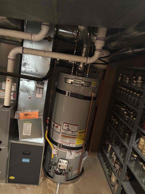 Removed defective 2021 water heater and transported to local supplier for warranty processing. Installed replacement water heater with new thermal expansion tank, supply connections, and aluminum drain pan with piping routed to floor drain. All plumbing connections completed and system tested for proper operation.