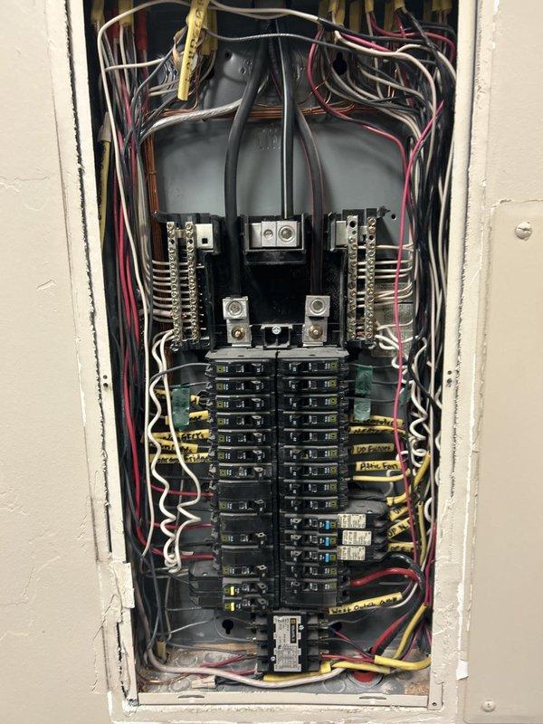 Completed comprehensive electrical maintenance inspection as part of recurring membership service. Performed thorough examination of main electrical panel, inspecting all circuit breakers, bus bars, and wire connections for proper operation and safety compliance. Verified integrity of approximately 20-30 branch circuit breakers across dual columns, examined main breaker assembly, and assessed all wire terminations including black, white, red, and yellow conductors. Documented panel condition through photography showing organized breaker arrangement and proper wire routing from service entrance through distribution points.