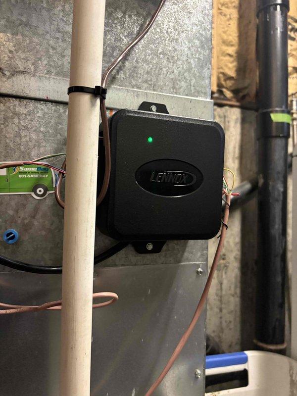 Responded to a no-heat callback on a basement furnace that cycled on briefly and shut down without producing warm air following a recent AC installation. Inspected the Honeywell thermostat (found set to System Off, Fan Auto, 65°F indoor reading) and the Lennox control module and low-voltage wiring at the furnace cabinet, verifying power indication and wiring connections. Reviewed findings and system operation to confirm proper thermostat configuration and control circuit condition.