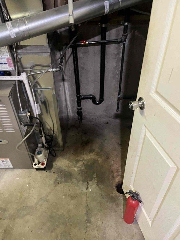 Responded to a sewer backup affecting multiple basement fixtures, including the mechanical room floor drain, shower, and tub, with active water discharge. Performed a sewer camera inspection of the drain line to assess the blockage and condition of the piping. Documented a damp, stained slab and a visible crack in the basement floor near the cast iron drain stack and floor drain.