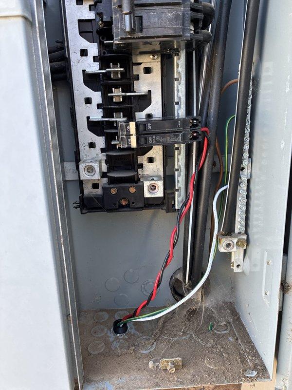 Installed a whole-home surge protective device at the outdoor service disconnect, landing conductors on a dedicated 50A two-pole breaker and connecting to the ground bar. Verified secure terminations, cleaned debris and cobwebs from the enclosure interior, and labeled the surge protector breaker at the panel door for future identification.