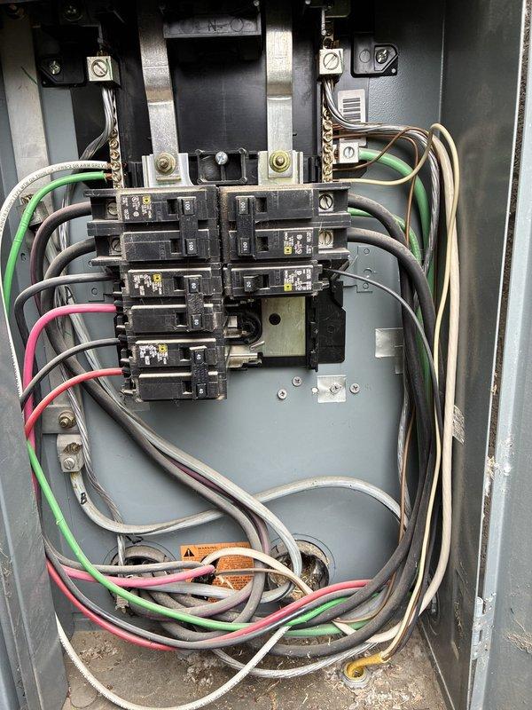 Performed annual electrical maintenance inspection of the main service panel, removing the dead front cover to visually inspect the service entrance conductors, lug terminals, bus bars, circuit breakers, neutral/ground bars, and branch circuit wiring. Documented panel conditions, including densely bundled and loosely looped branch conductors, debris and loose hardware in the enclosure floor, and discoloration beneath the lower breakers, and recommended further evaluation of those areas.