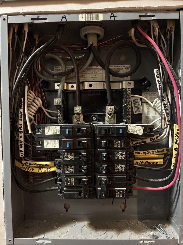 Performed annual electrical maintenance inspection of the main service panel, removing the dead front cover to visually inspect the service entrance conductors, lug terminals, bus bars, circuit breakers, neutral/ground bars, and branch circuit wiring. Documented panel conditions, including densely bundled and loosely looped branch conductors, debris and loose hardware in the enclosure floor, and discoloration beneath the lower breakers, and recommended further evaluation of those areas.