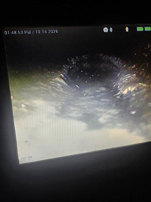 Responded to a reported sewer backup affecting the basement floor drain, which worsened with household water use. Performed a camera inspection of the main sewer line using a RIDGID SeeSnake, reaching approximately 50 feet, and documented standing water, buildup, and debris or a possible obstruction/joint irregularity within the line, consistent with a restriction causing the backup. Findings were recorded for review and to determine the appropriate corrective action.