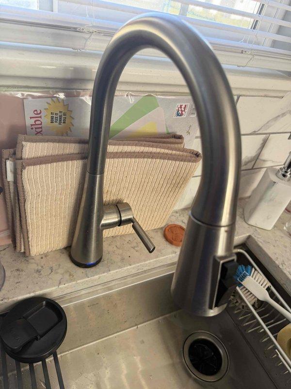 Performed a plumbing member inspection of the kitchen fixtures and under-sink components. Inspected the garbage disposal, including the mounting flange, slip-joint drain fittings, flexible discharge hose with clamp, and electrical connection, along with the brass shutoff valves and braided supply lines, and found no leaks, corrosion, or damage. Evaluated the pull-down kitchen faucet and sink drain, which were in good condition with no deficiencies noted.