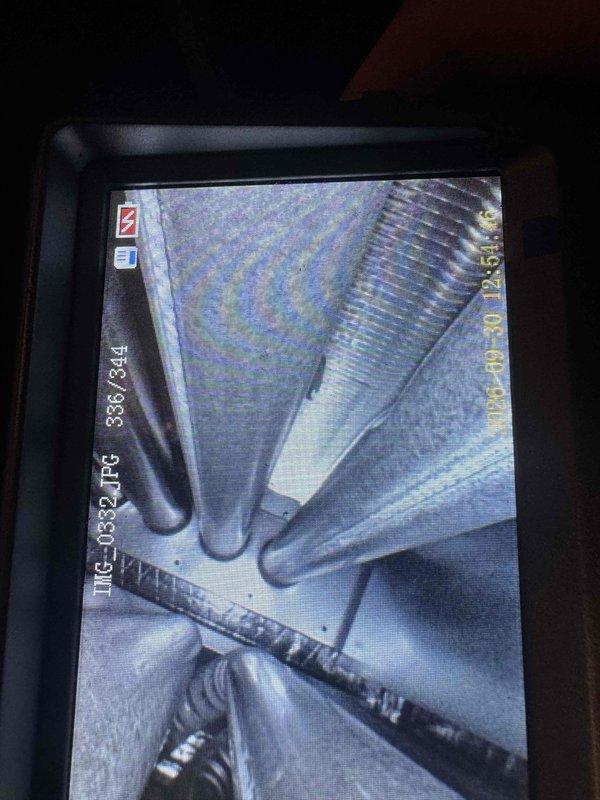 Performed seasonal tune-ups on two basement furnaces, including combustion analysis with a flue gas analyzer and visual inspection of the evaporator coil using a borescope camera, which showed clean coil surfaces with no frost, rust, or visible damage. Drain line repair on one unit had already been completed by the customer prior to the visit, and both systems were left operating normally.