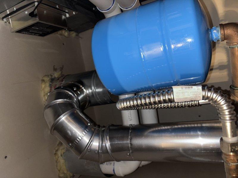 Inspected a 12-year-old tanked Bradford White gas water heater reported to underperform on hot water delivery, and assessed the unit, gas connector, flue venting, supply/relief piping, and thermal expansion tank, finding no visible leaks, rust, or damage. Evaluated the system for replacement and provided a replacement estimate based on the unit's age and reduced heating performance.