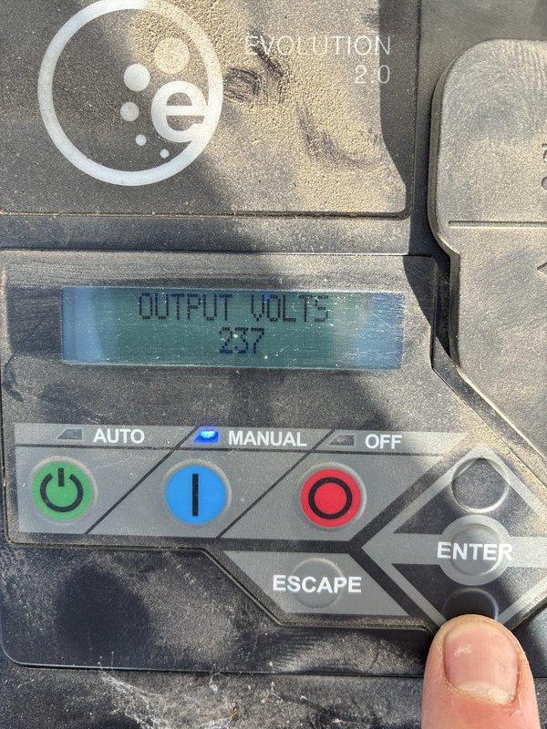 Responded to a report of a standby generator not supplying power to the building. Inspected the Evolution 2.0 controller and found the unit running in Manual mode with output readings of 237 V and 58.9 Hz, indicating the generator was producing power. Cleaned heavy dust, dirt, and cobweb buildup from the control panel and surrounding unit to restore access and visibility of the controls and display.