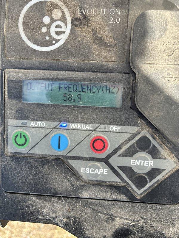 Responded to a report of a standby generator not supplying power to the building. Inspected the Evolution 2.0 controller and found the unit running in Manual mode with output readings of 237 V and 58.9 Hz, indicating the generator was producing power. Cleaned heavy dust, dirt, and cobweb buildup from the control panel and surrounding unit to restore access and visibility of the controls and display.