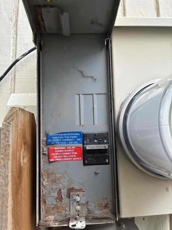 Performed an electrical maintenance inspection of the exterior main service panel, which includes a 150A main breaker and a PV system backfeed breaker with required solar labeling. Documented significant rust and corrosion on the enclosure interior, along with debris and cobweb buildup, and noted oxidation and crusty residue on the bus stab contacts. These conditions indicate moisture intrusion and potential connection degradation, and further evaluation or corrective repair of the panel is recommended.