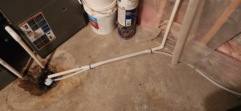 Installed a new Sentry II water softener with a digital control head in the utility room, connecting it to the home's plumbing with isolation/bypass valves and flexible supply lines. Routed the drain line to the existing floor drain, secured it with zip ties, and verified a clean installation with no visible leaks or damage.