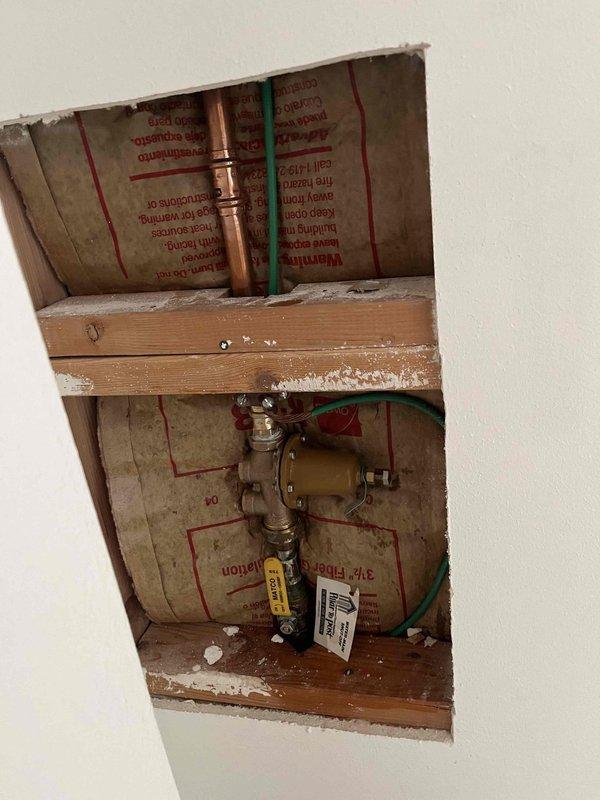 Installed a new 40-gallon gas-fired tank water heater in the existing mechanical alcove with all code-required upgrades, including new water and gas connections, shutoff valves, a corrugated flexible gas connector, and a flue connection to the existing vent. Installed a drain pan piped to the floor drain for leak containment, seismic strapping, and a thermal expansion tank pressurized to match the home's static water pressure. Verified the existing pressure-reducing valve and shutoff assembly in the wall cavity were intact with no visible leaks, and completed all required permitting and inspections.