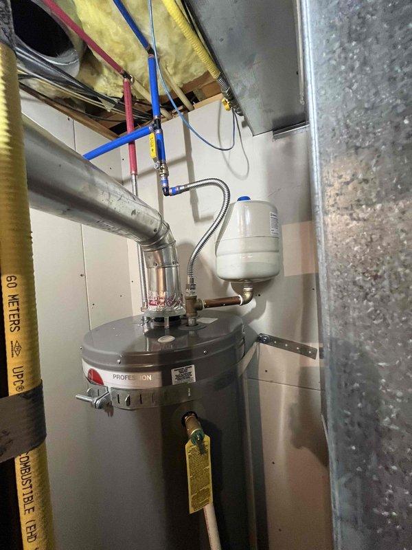 Installed a new 40-gallon gas-fired tank water heater in the existing mechanical alcove with all code-required upgrades, including new water and gas connections, shutoff valves, a corrugated flexible gas connector, and a flue connection to the existing vent. Installed a drain pan piped to the floor drain for leak containment, seismic strapping, and a thermal expansion tank pressurized to match the home's static water pressure. Verified the existing pressure-reducing valve and shutoff assembly in the wall cavity were intact with no visible leaks, and completed all required permitting and inspections.