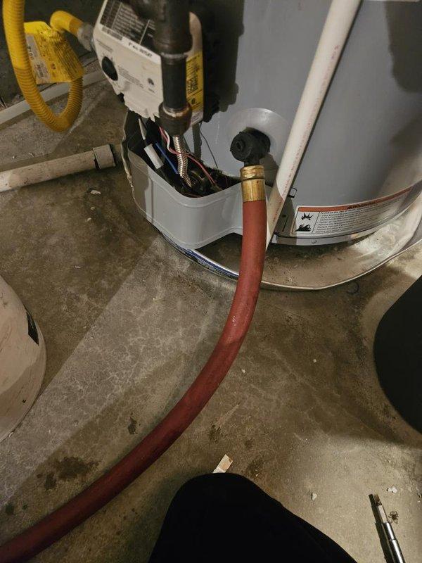 Performed annual plumbing maintenance inspection, including a system pressure test using a gauge at the exterior hose bibb and a water purity test. Flushed the gas water heater through the tank drain valve to remove sediment and verified the gas control assembly and connections were intact. Noted a minor drip at the hose bibb packing nut, indicating the packing nut may need to be tightened or the packing replaced.