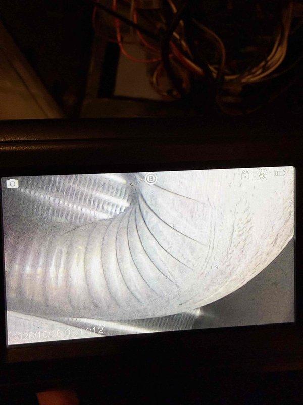 Performed a second-opinion callback inspection on the furnace following a prior heat exchanger recommendation. Used an inspection camera to examine the supply ductwork and internal heat exchanger cavity. Duct interior showed light dust and residue with no obstruction. Imaging of the heat exchanger area revealed heavy corrosion and rust deterioration on the perforated component, along with amber and yellow staining and residue streaks along adjacent seams, indicating possible moisture exposure and combustion-related degradation. Findings were documented with photos for the customer's review.