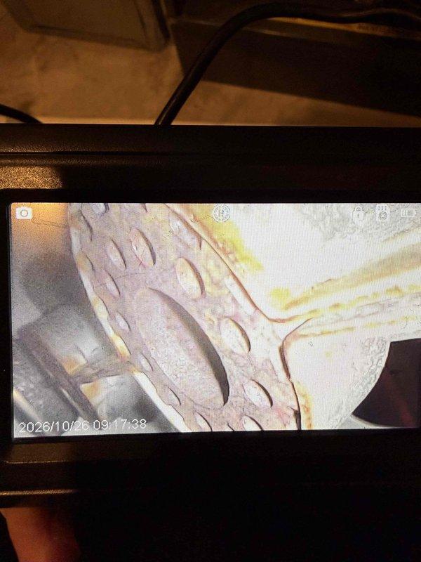 Performed a second-opinion callback inspection on the furnace following a prior heat exchanger recommendation. Used an inspection camera to examine the supply ductwork and internal heat exchanger cavity. Duct interior showed light dust and residue with no obstruction. Imaging of the heat exchanger area revealed heavy corrosion and rust deterioration on the perforated component, along with amber and yellow staining and residue streaks along adjacent seams, indicating possible moisture exposure and combustion-related degradation. Findings were documented with photos for the customer's review.