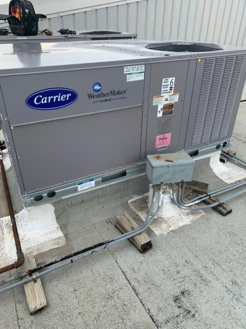 Barbosa Plumbing & AC used a crane to replace the rooftop ac system on a commercial building.