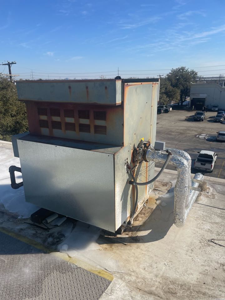 Commercial roof rooftop boiler damaged. Boiler heat exchanger is cracked causing water to leak inside of building.