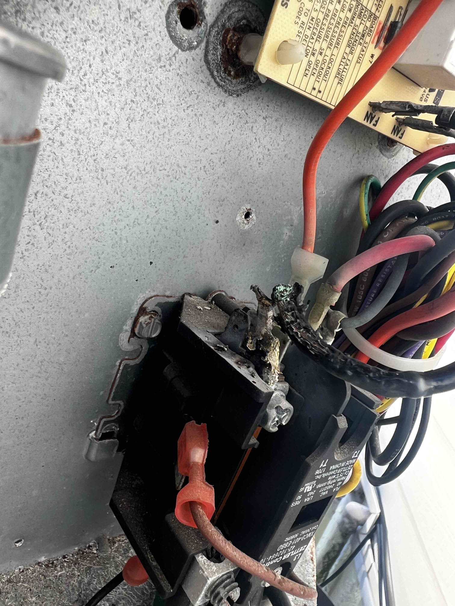 On arrival found unit not cooling due to burnt contactor. Replaced part. Start and test. Replaced filter for client. Unit has 21* split. Thermostat reading accurately. Unit cooling at this time.