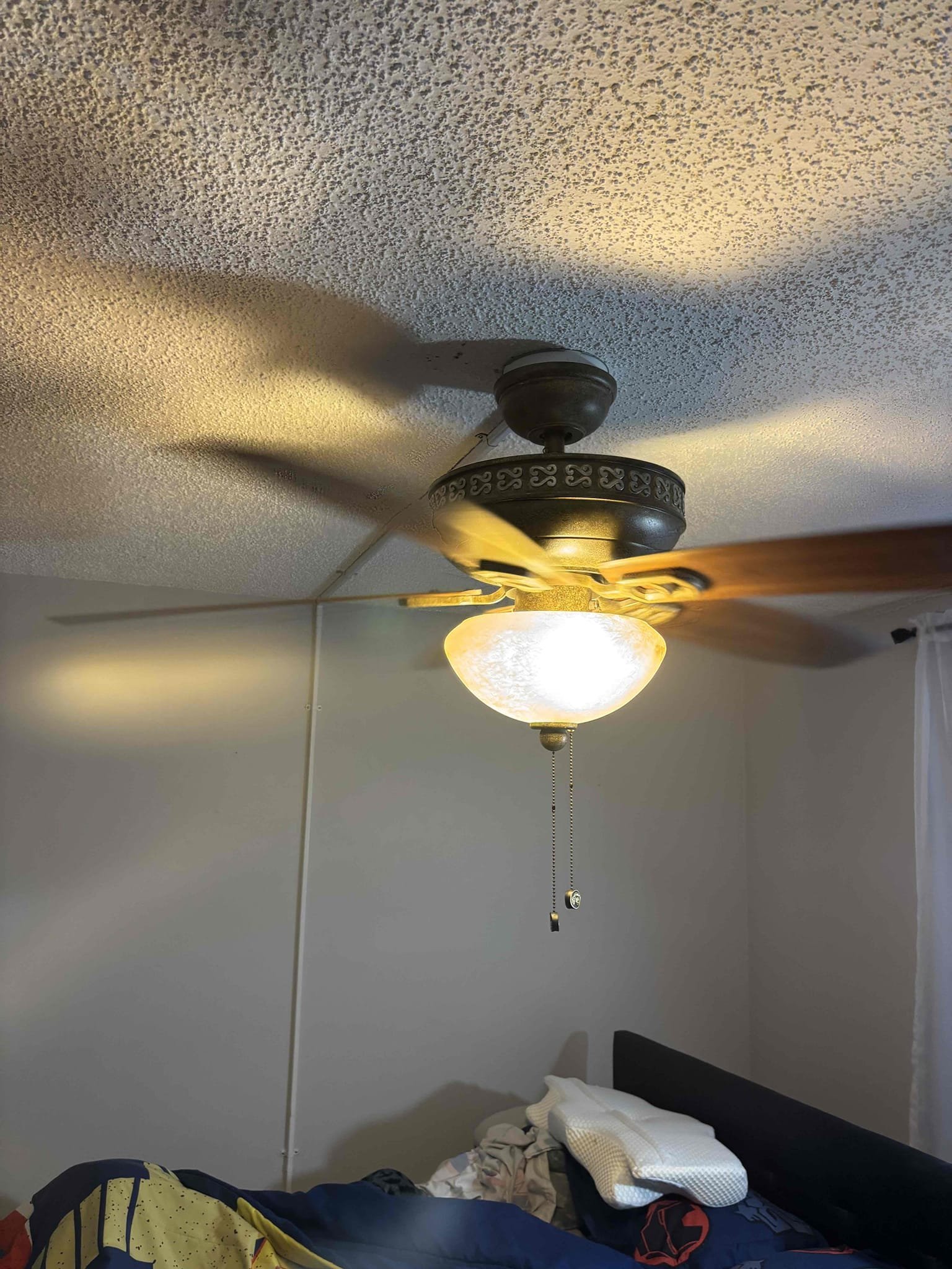 Cut in ceiling fan box 
Set a junction box in the attic and tie into fan box so fan can be powered by switch  Cut in ceiling fan box 
Set a junction box in the attic and tie into fan box so fan can be powered by switch