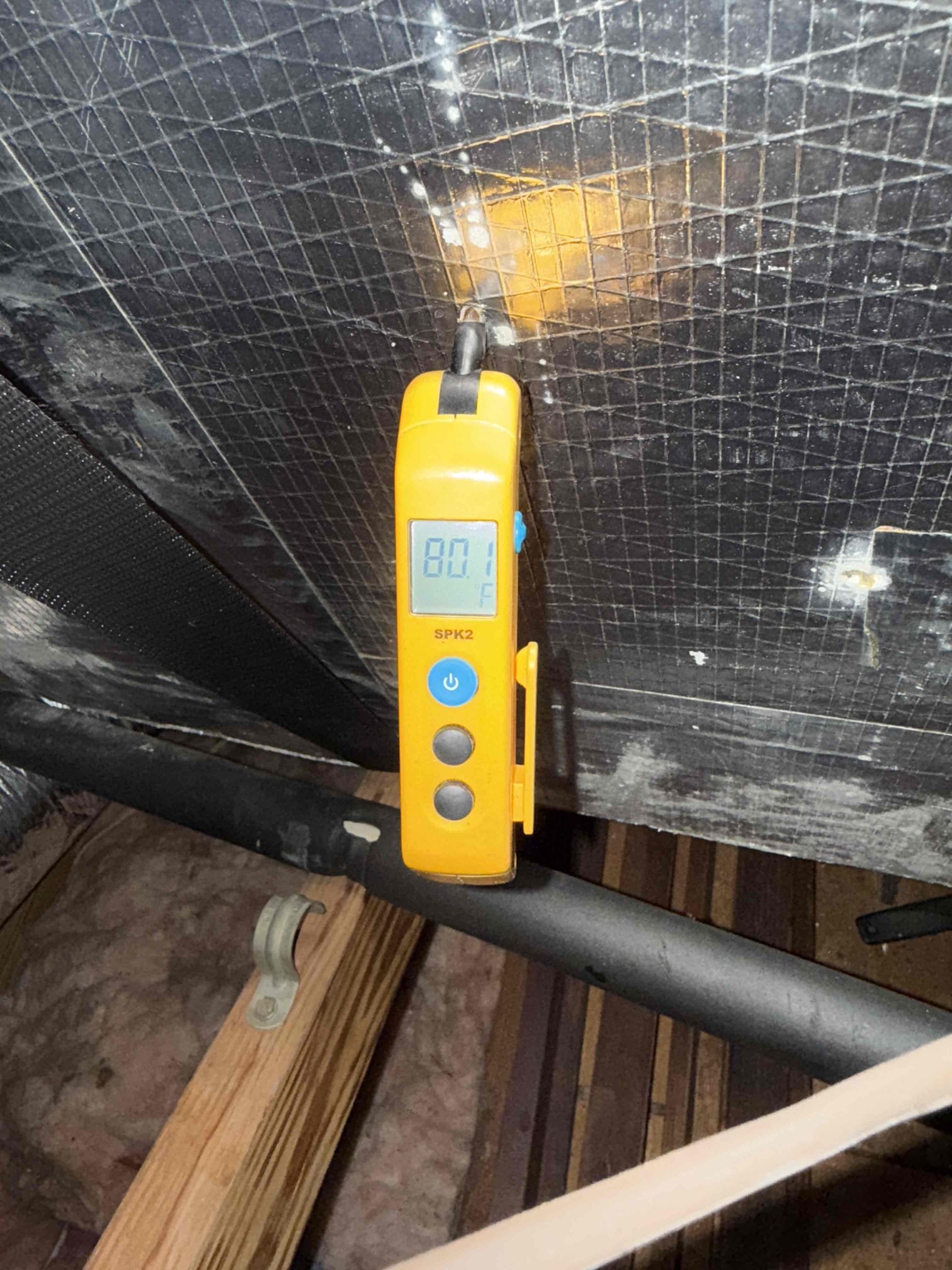 Upon my inspection, found clogged drain line and full safety pan. Performed a deep drain cleaning and treatment. Found system was one pound low on refrigerant. Charged system with refrigerant and achieved target superheat. System had a 14° temp split and now has a 18° temp split. System is cooling properly at this time. 

Secondary safety drain pan is undersized for unit. 
Thermostat is not fastened to the wall properly and the display is broken. Quoted for installing client supplied thermostat. 