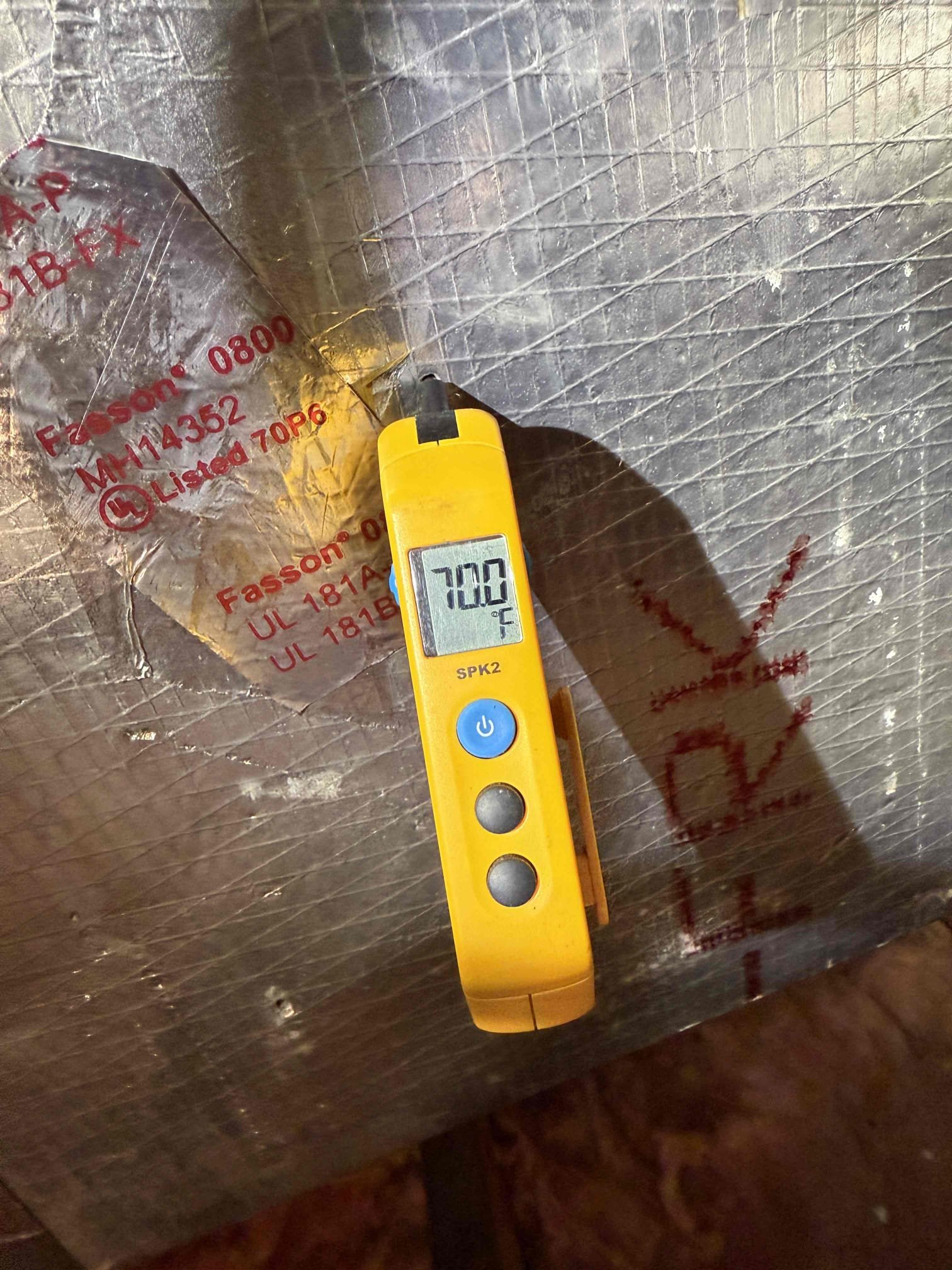 Upon my inspection, found clogged drain line and full safety pan. Performed a deep drain cleaning and treatment. Found system was one pound low on refrigerant. Charged system with refrigerant and achieved target superheat. System had a 14° temp split and now has a 18° temp split. System is cooling properly at this time. 

Secondary safety drain pan is undersized for unit. 
Thermostat is not fastened to the wall properly and the display is broken. Quoted for installing client supplied thermostat. 