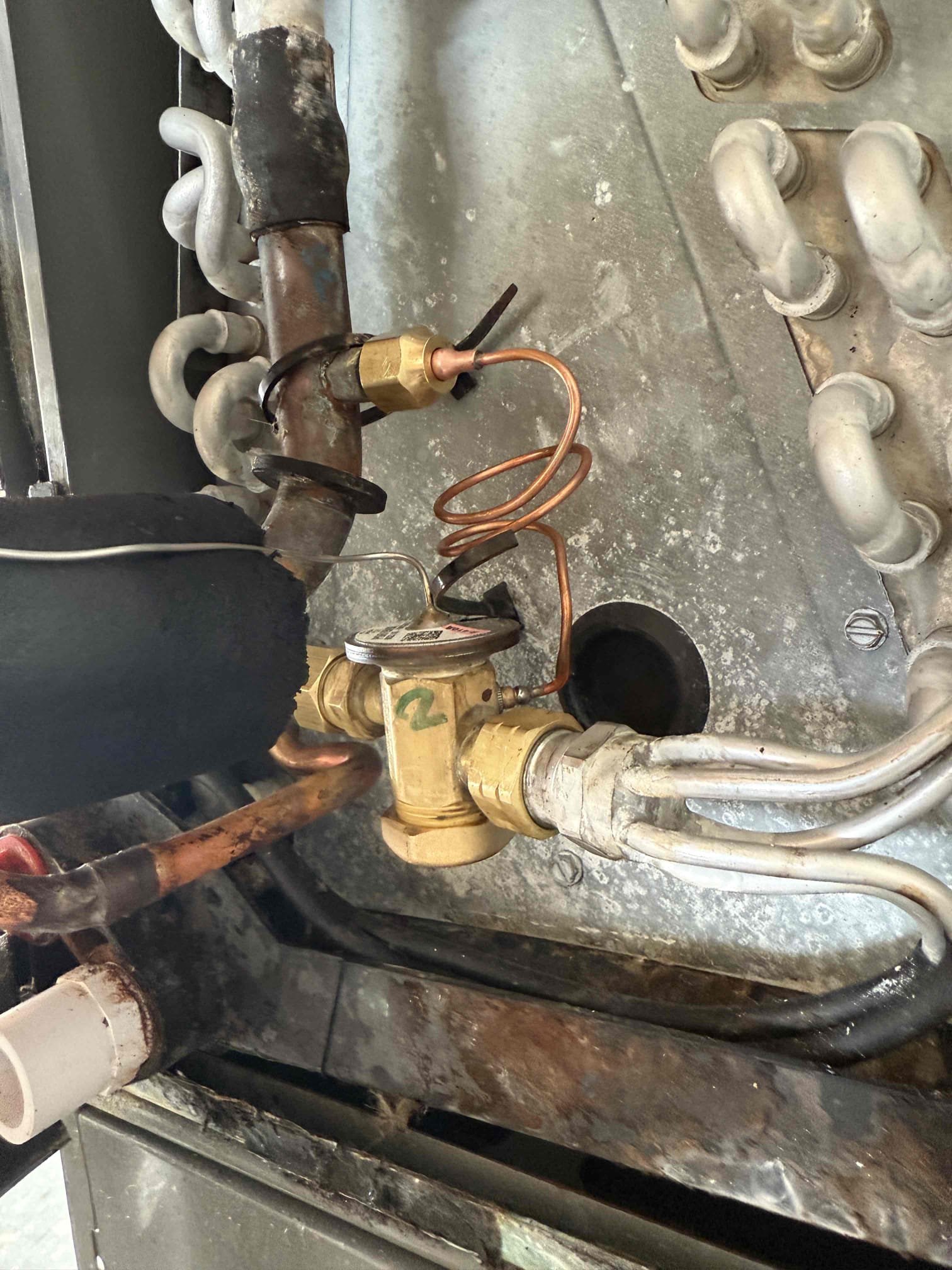 Replaced warranty TXV. Replaced liquid line filter dryer.  Achieved 20° temperature split. Achieved 13° subcool. System is cooling properly at this time. 