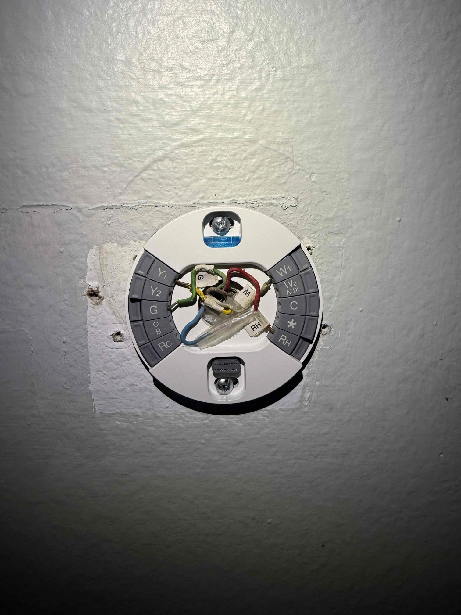 Upon my inspection? Found system thermostat wire to condenser was broke in half. Replaced wire from gutter to condenser. Inspected rest of system. Condenser is in a hard to service spot up against the wall. Checked capacitor. System is cooling at this time. System needs a Maitenence. Client would not like to invest more money into 17 year old system at this time. Indoor blower motor has oil residue. High voltage coming into air handler is questionable. There is only one safety float switch. 