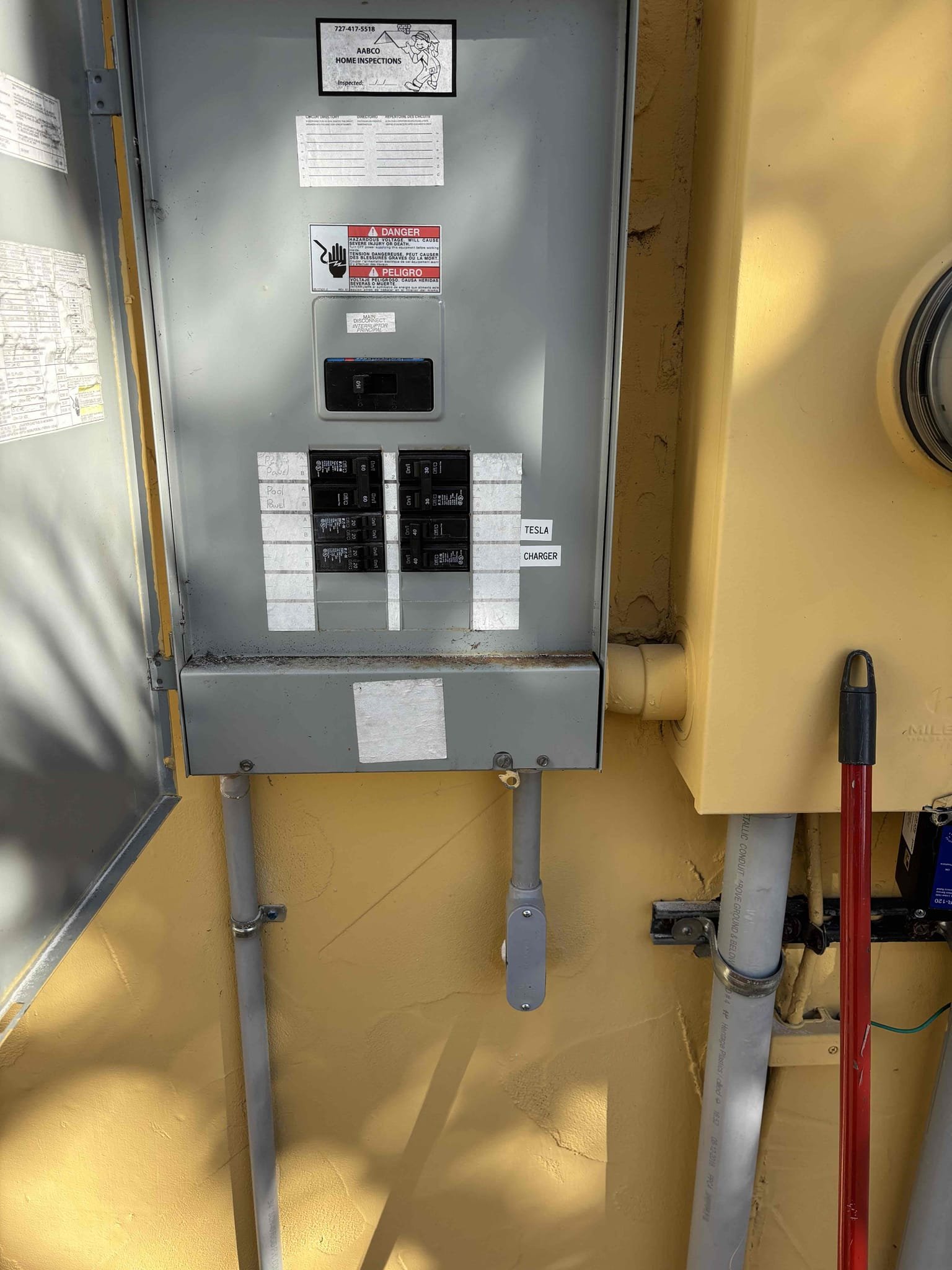 Install electrical for Tesla car charger in garage 
Run conduit to exterior panel 
Make space inside of panel for 2 pole breaker 