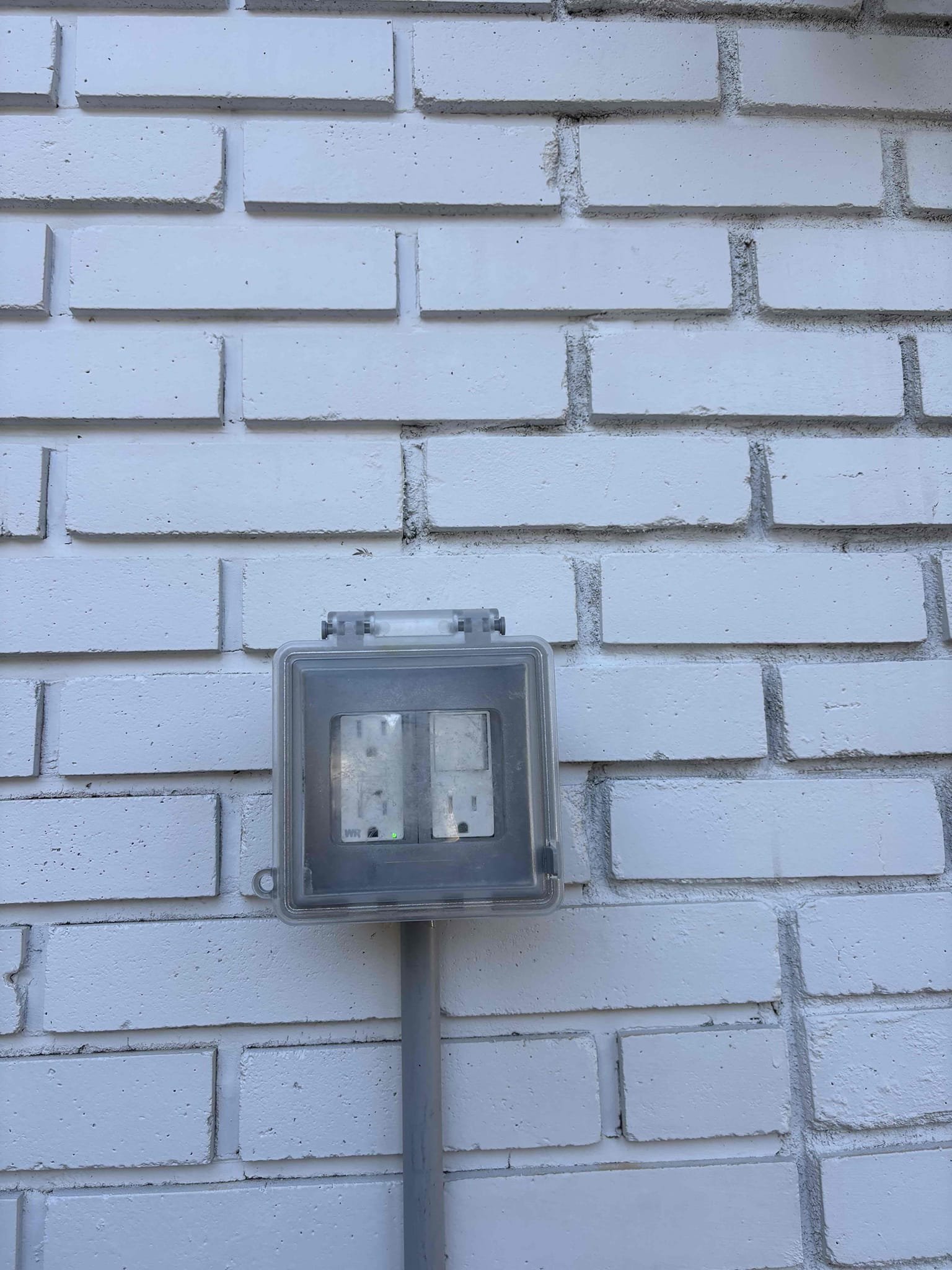 Run conduit exposed on the wall to new outlet location 
Install weatherproof box and in use cover 
Install tandem breaker 
Install weather resistant GFCI 
Adding customer supplied switched recep to GFCI box 