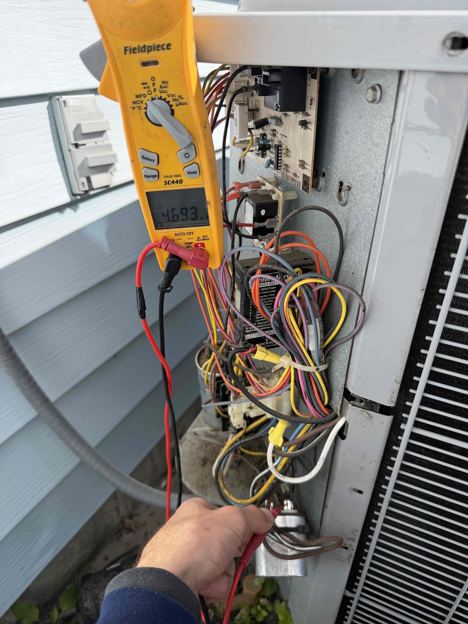 Upon my inspection, found a severely clogged drain line and secondary safety pin was full of water. This tripped the safety float switch and the thermostat turned off. Cleaned and treated drain line and primary drain pan as well as emptying out the secondary safety pan. Check the system and cooling and heating. System is heating properly at this time. Amp draws on the compressor and fan motor are good. Evaporator coils are slightly dirty. The capacitor for the compressor is out of its factory tolerance limit. The fan motor capacitor is barely out of its tolerance limit. Found low voltage wiring at the condenser showing bare copper and at risk of shorting out the fuse. 
Made all necessary repairs besides the fan motor capacitor. 

Despite unit age and condition, client does not want to move forward with a new system before selling the house in the summer. 