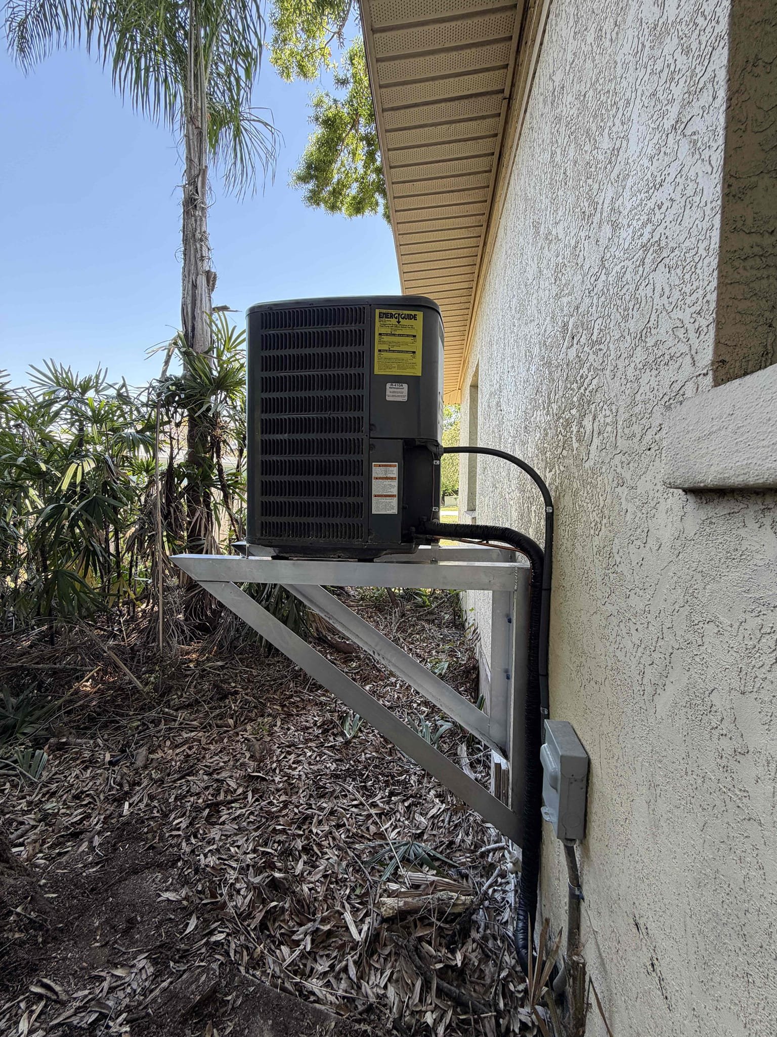 Scope of work:
- Disconnect condenser unit
- Raise condenser on wall mount brackets
- Extend low voltage to condenser
- Extend high voltage electrical to condenser from disconnect
- Extend copper lineset
- Install new UV rated insulation
- Hurricane strap unit to wall mount brackets
*No guarantee of system working due to system age being 16 years old*

After completion, home still does not have power. Told Leah to give us a call if there’s any issues in the future once power is restored. 