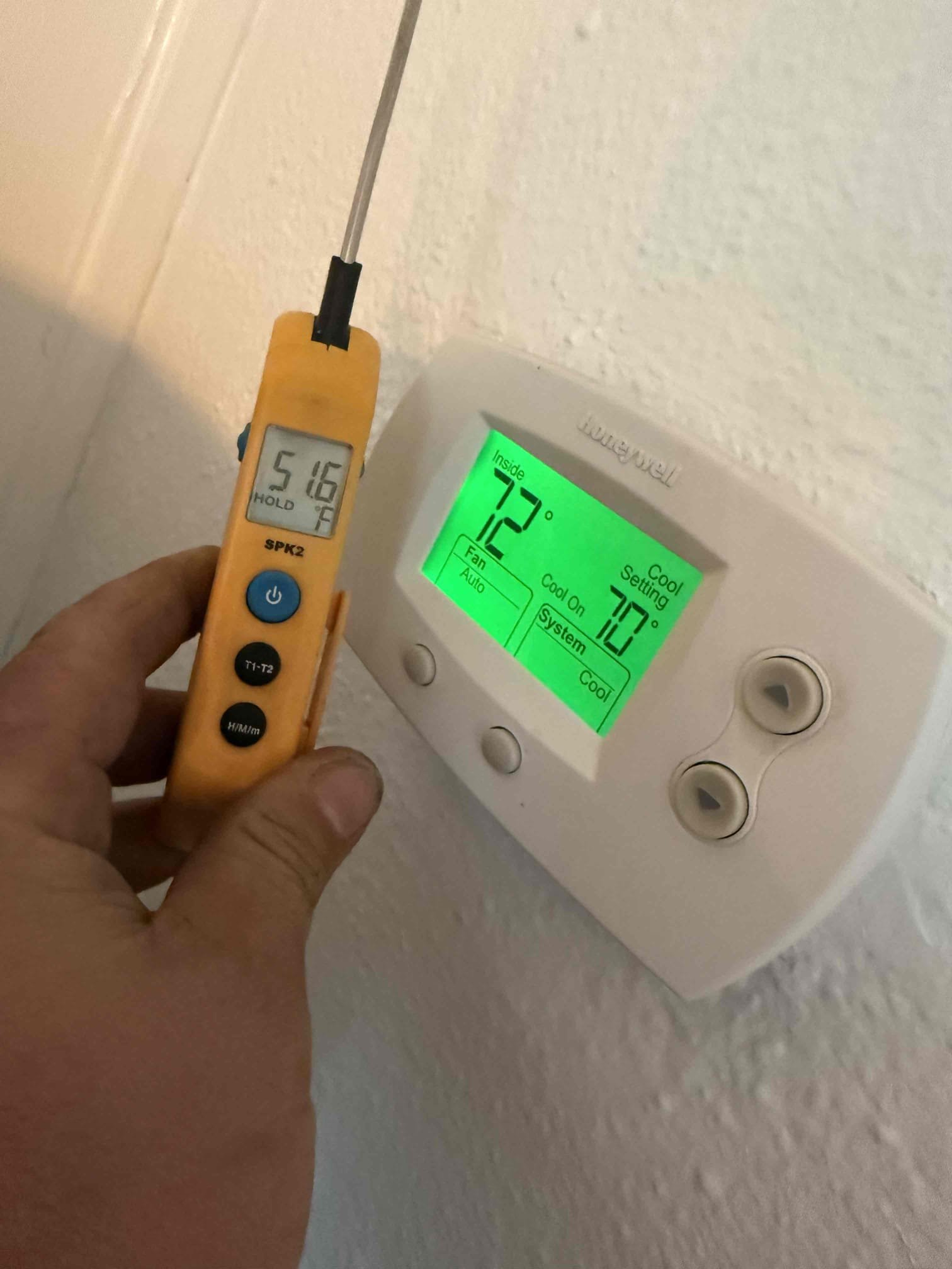 On arrival found downstairs unit not cooling due to bad blower motor. Replaced motor. Start and test. Unit is cooling properly. Replaced bad section of thermostat wire for upstairs condenser. 