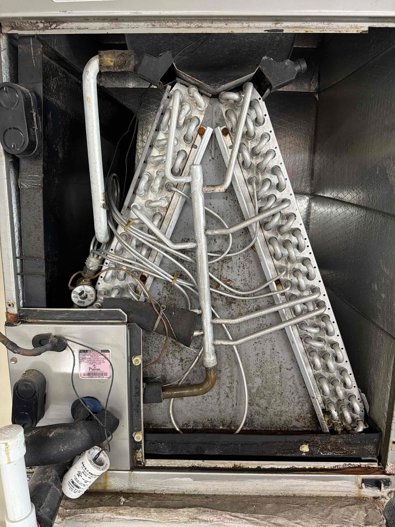 Found system freezing up due to severely clogged and impacted evaporator coils. System may also be low on refrigerant but we cannot accurately determine without proper air flow. Found lizard burnt on contactar and capacitor near its max tolerance limit. 
System cannot cool properly at this time. Client would like a system replacement estimate. Quote has been sent over. 