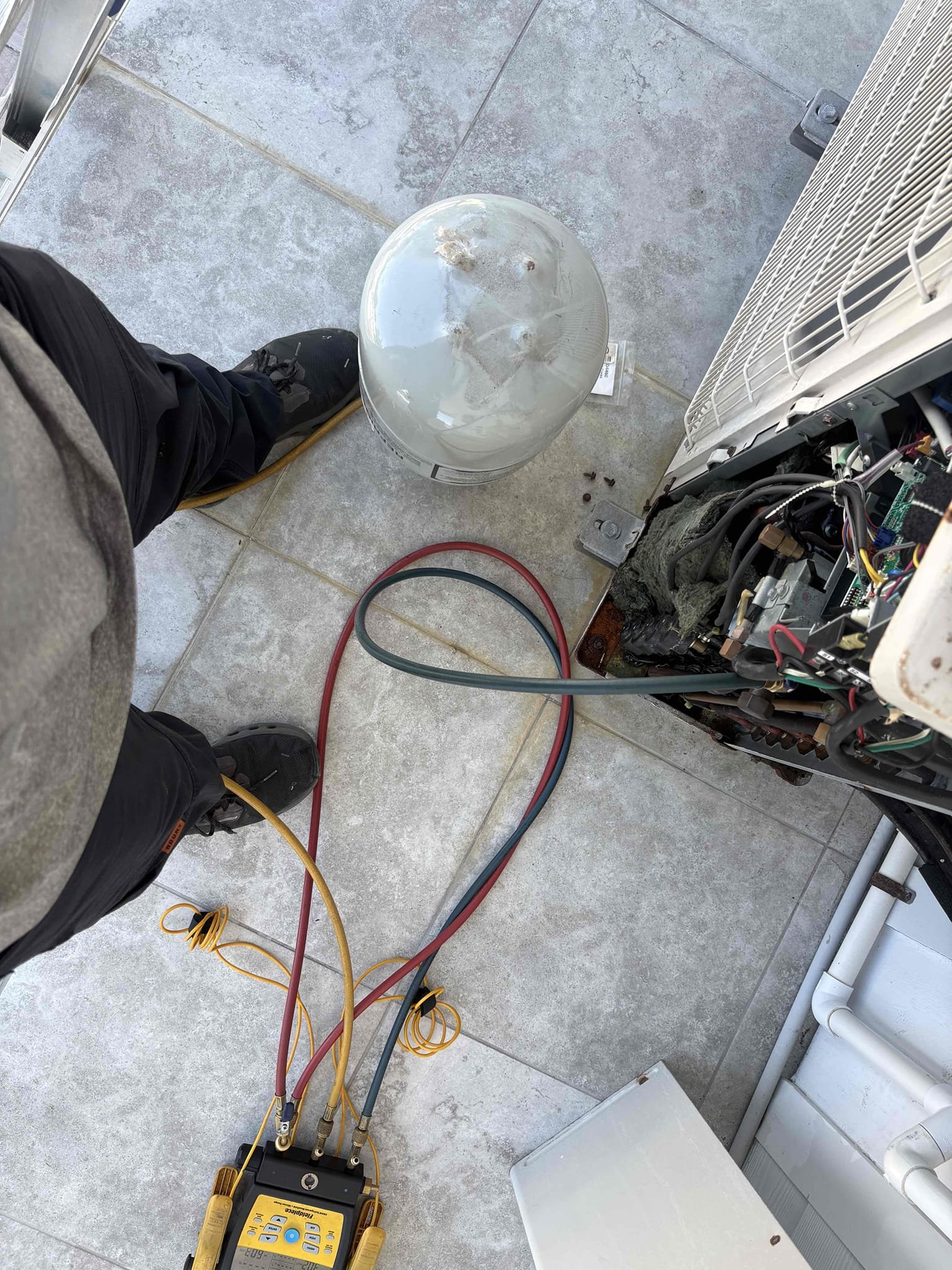 Return to complete leak search on system. Removed filter cover snd doors on 4 cassette head units. Leak searched coils and connections points. Did not find any issues inside. Searched entirety of outdoor unit. Found schrader core leaking and gasket to cap missing. Replaced core and added new cap. Verified new core not leaking. Added refrigerant back to factory specifications and verified system operations. 