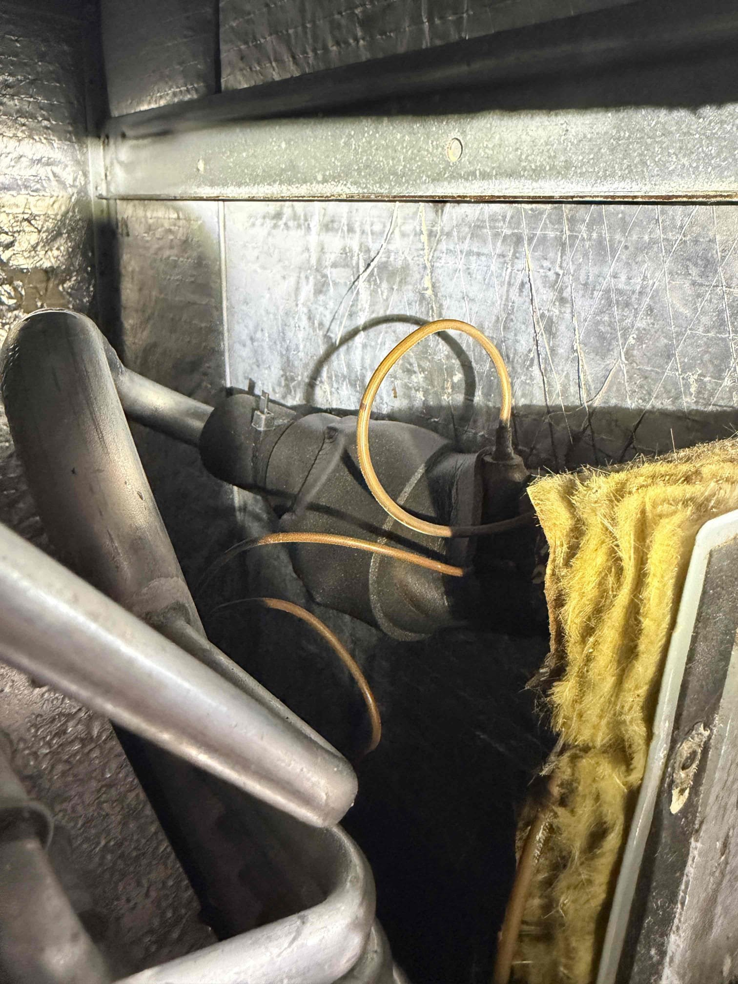 Home is short term rental occupied. Current tenant states that system is not cooling down and the thermostat is not reading the proper temperature. 
Upon my inspection, found thermostat about 10° off from actual temperature inside home. Re calibrated thermostat. 
System is low on refrigerant. Found refrigerant leak at a copper connection at the air handler. It appears that the installation brazing of the copper connections is poor and best install practices were not followed. Repaired leak and re charged system with refrigerant after a proper vacuum. 
While system is running, pressures, subcool, and superheat all indicate that the TXV is not metering refrigerant properly. It appears that the TXV has been tampered with in the past and there are non OEM zip ties and insulation on parts of the TXV device. Therefore we recommend replacing the TXV. 
The capacitor is reading very weak and should be replaced to prevent a break down in the near future. Replaced capacitor today. 
The condenser 