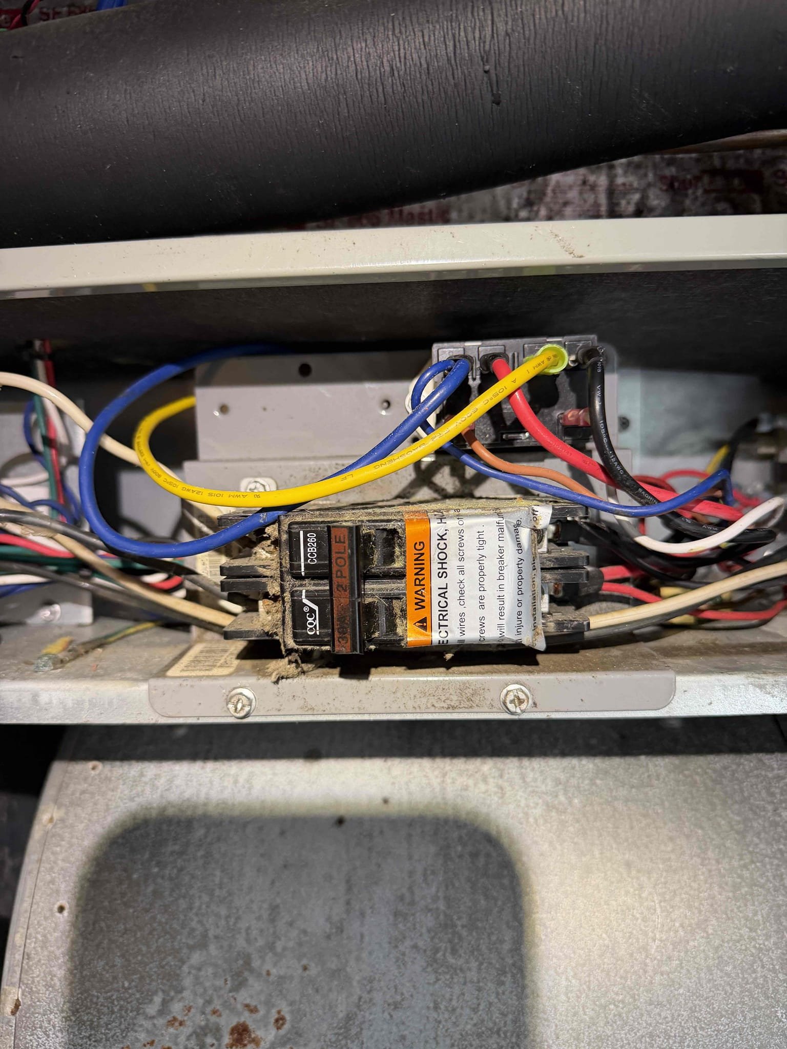 Upon my inspection, found tripped air handler breaker. Tried to reset breaker and it continued to trip. Turned power off by the breakered disconnect at the air handler and reset main breaker. Power stayed on. Disconnected blower motor high voltage plug and turned air handler breaker disconnect at unit back on and power still on. Turned off and reconnected blower motor and turned power back on. System is cooling at this time with a 24° temp split. Coils are a little dirty. 
Advised client that if issue persists, we will need to start replacing breakers if they are weak. 
