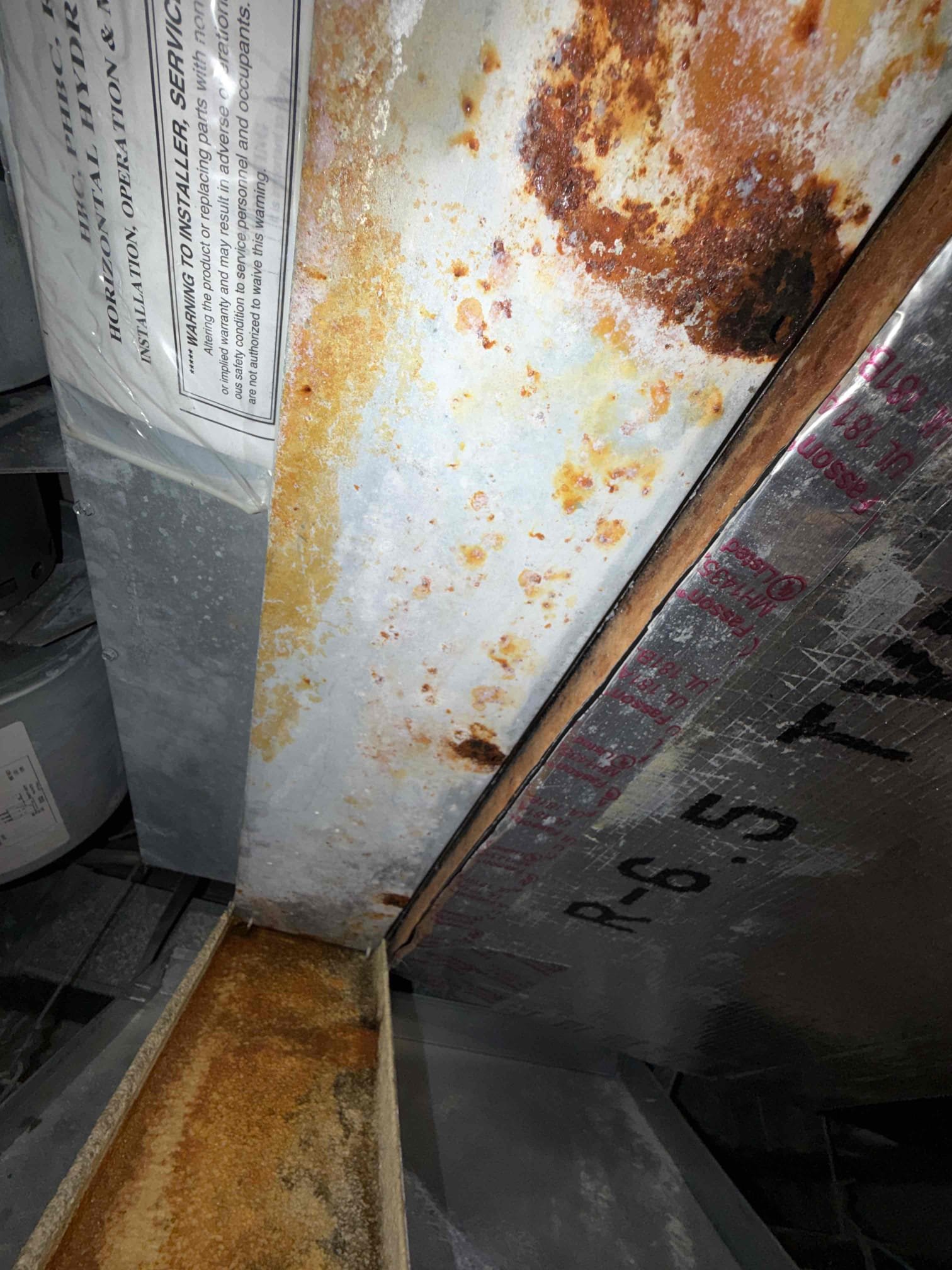 Upon my inspection, found main evaporator metal drip pwn clogged with rust and debris. Performed a pan removal and cleaning on unit. System is now draining properly. 