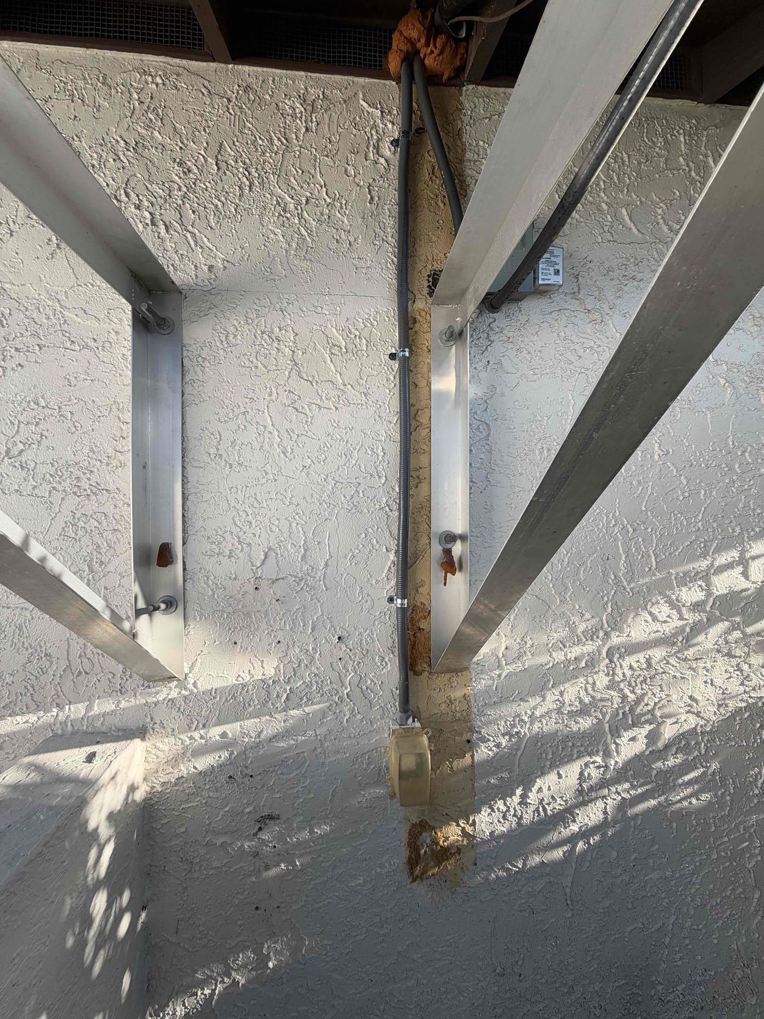 Run new sleeve for exposed electrical wire next to condenser. Tax and labor included.