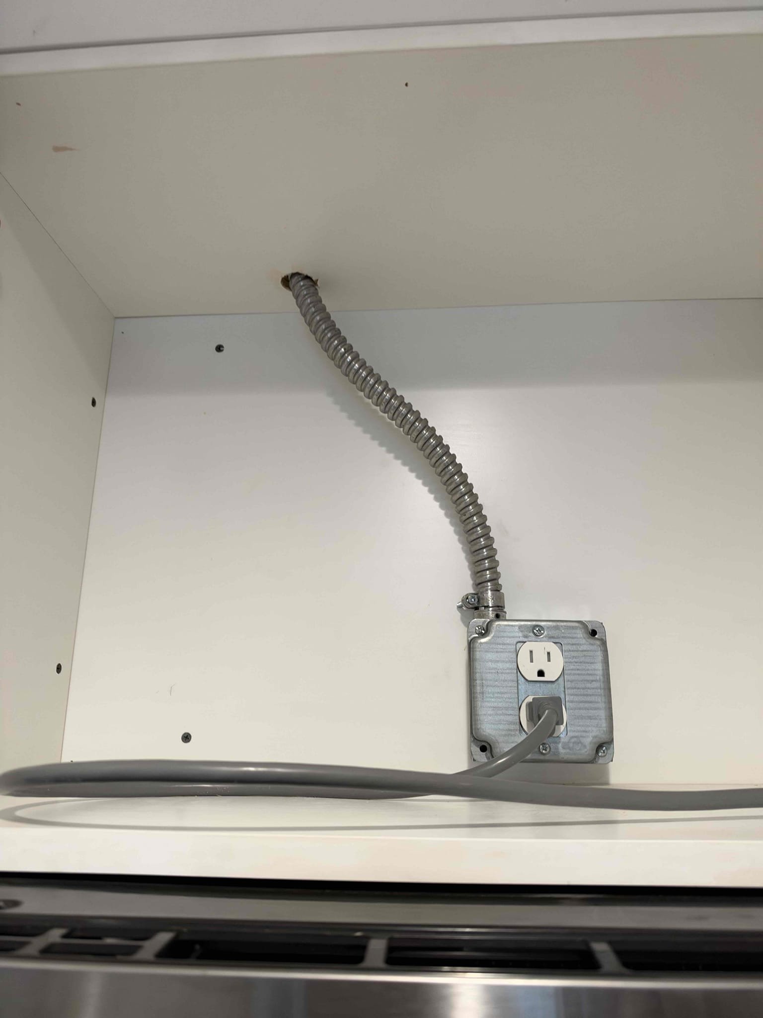 Run a new dedicated circuit to the microwave install 2 new breakers in the panel disconnect existing microwave circuit 

Very