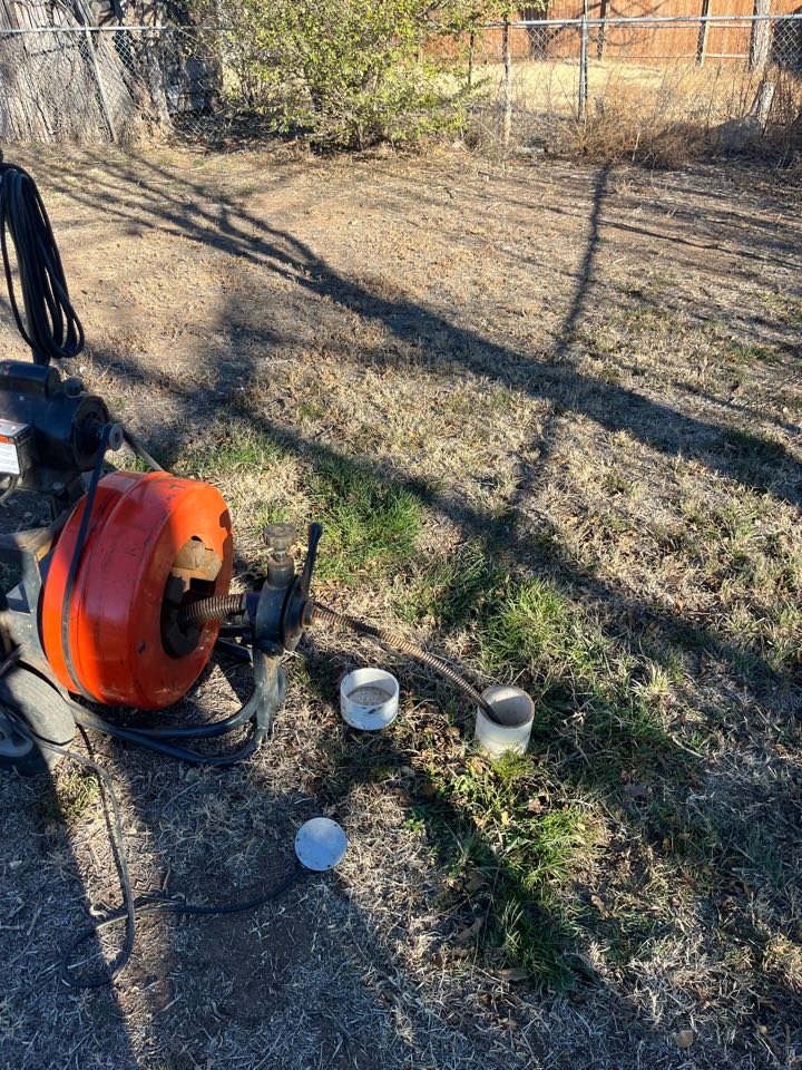 Ran sewer machine through outside, clean out and cleared stoppage