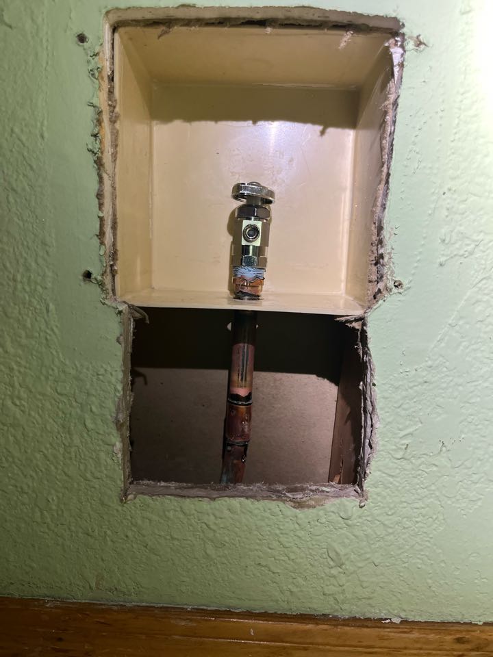 Replace a leaking shut off valve behind the refrigerator. 