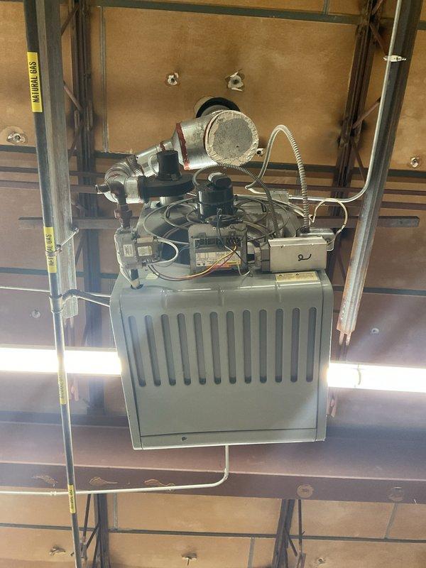 Serviced two ceiling-mounted heaters in commercial space. Diagnosed first unit making abnormal noise as having worn blower motor bearings requiring replacement. Second non-operational unit found with failed ignition control module and gas valve; replaced both components and verified proper operation. Both heating systems now functioning correctly with normal flame pattern and appropriate temperature rise.