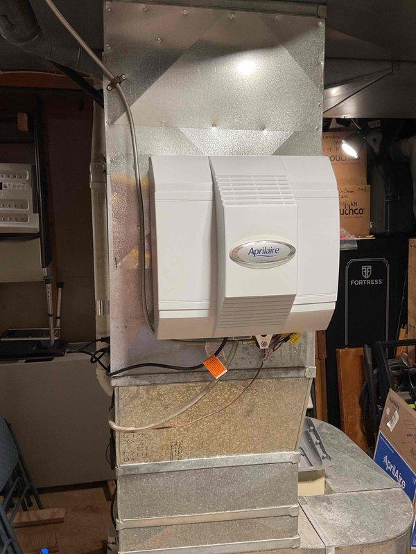 Successfully installed an Aprilaire power humidifier on the existing HVAC system in the utility room. Unit was properly mounted to the ductwork with all necessary electrical connections completed and verified operational.