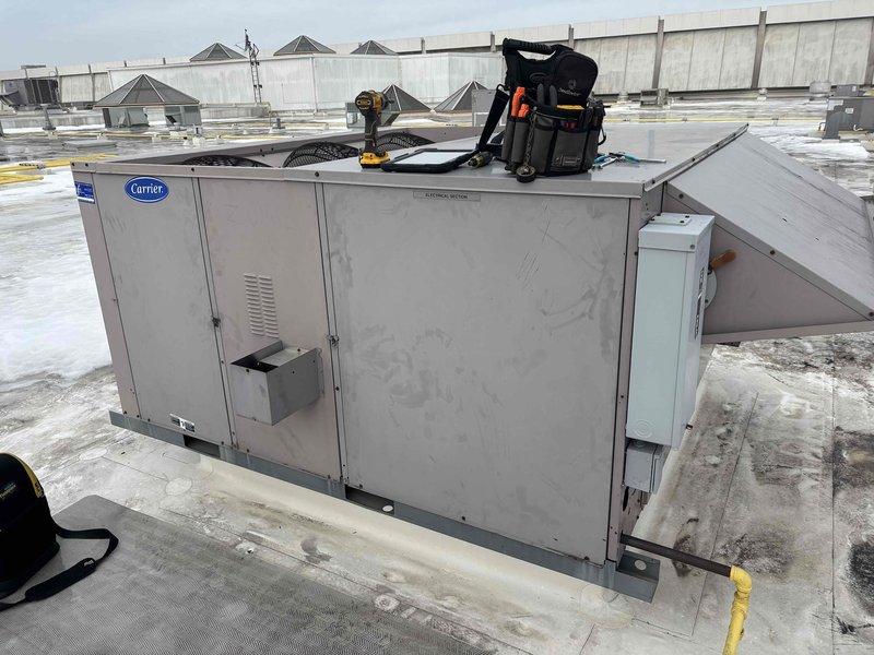 Responded to no heat complaint at commercial site where indoor temperature was registering only 60-62°F. Upon inspection of the Carrier rooftop unit, diagnosed issue with drive belt system. Replaced worn belt and verified proper tension across pulleys, restoring normal heat operation.