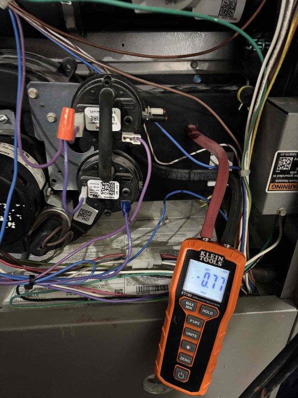 Responded to customer complaint of no heat after previous drain tap clearing. Multimeter diagnostic revealed -0.77" reading on pressure switches. Inspected low fire pressure switch and found it was malfunctioning. Ordered replacement pressure switches to restore proper furnace operation.