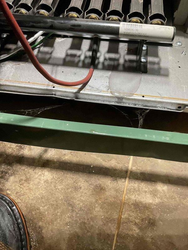 Responded to warranty service call for boiler leakage issues. Inspection revealed water leaking from inside the boiler behind the front cover and dripping from the plenum onto the floor. Visual examination confirmed heat exchanger failure, which was the source of the leak and causing no-heat condition.