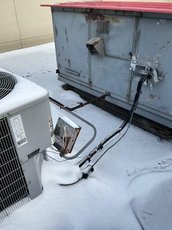 Responded to no heat complaint at customer's laundromat. Upon roof inspection, found significant exterior corrosion on RTU with damaged panels and compromised housing. Identified failed gas valve preventing proper ignition sequence, replaced valve and verified proper operation of heating cycle.