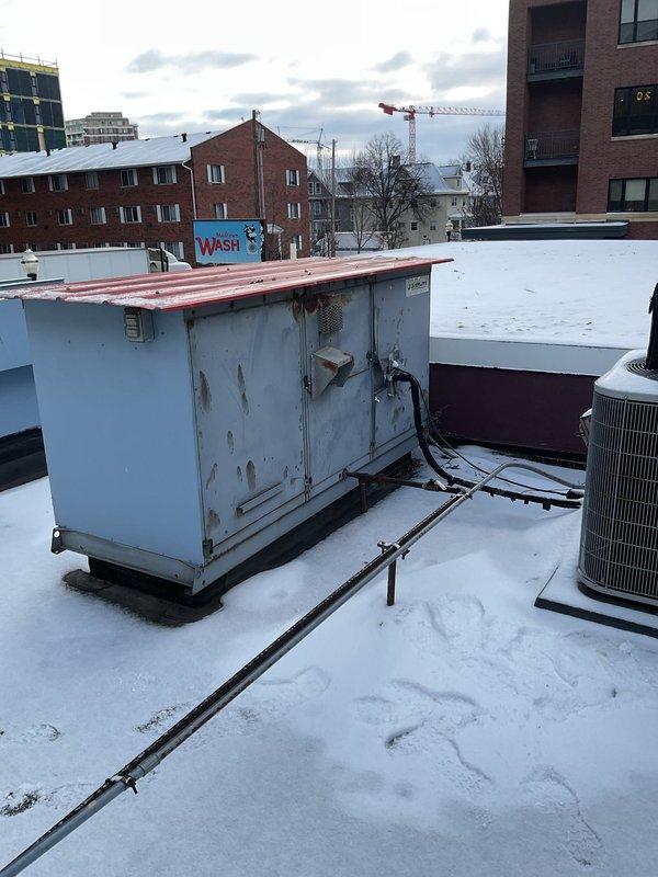 Responded to no heat complaint at customer's laundromat. Upon roof inspection, found significant exterior corrosion on RTU with damaged panels and compromised housing. Identified failed gas valve preventing proper ignition sequence, replaced valve and verified proper operation of heating cycle.