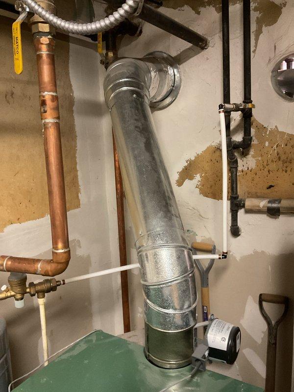 Responded to customer report of boiler issues after providing 30-minute advance notice. Upon inspection, discovered wet igniter wire and significant water leakage from the heat exchanger. Diagnostic assessment confirmed heat exchanger failure requiring complete replacement. Documented corrosion at pipe connections and visible water damage to surrounding wall area as supporting evidence.
